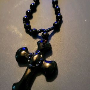 A beautiful black cross on a necklace